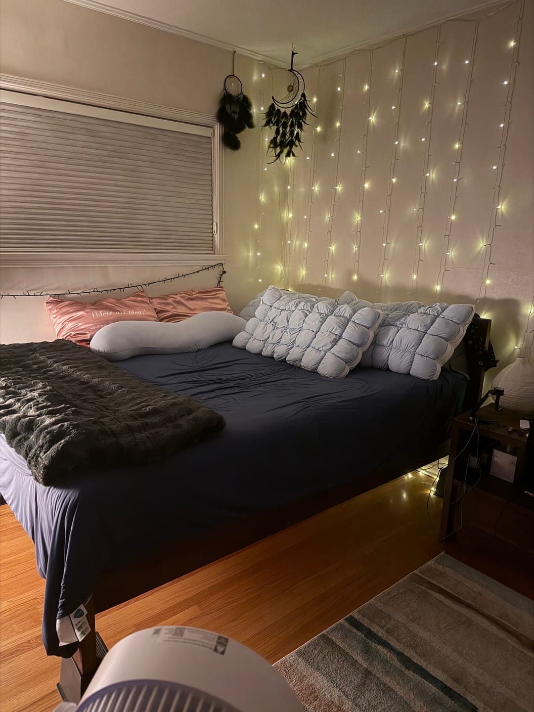 Chillora comforter on a bed in a bedroom with fairy lights